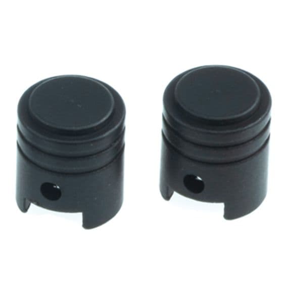 Black alloy valve caps with a piston shape, featuring a smooth top and a cut-out design at the base for easy installation and removal.