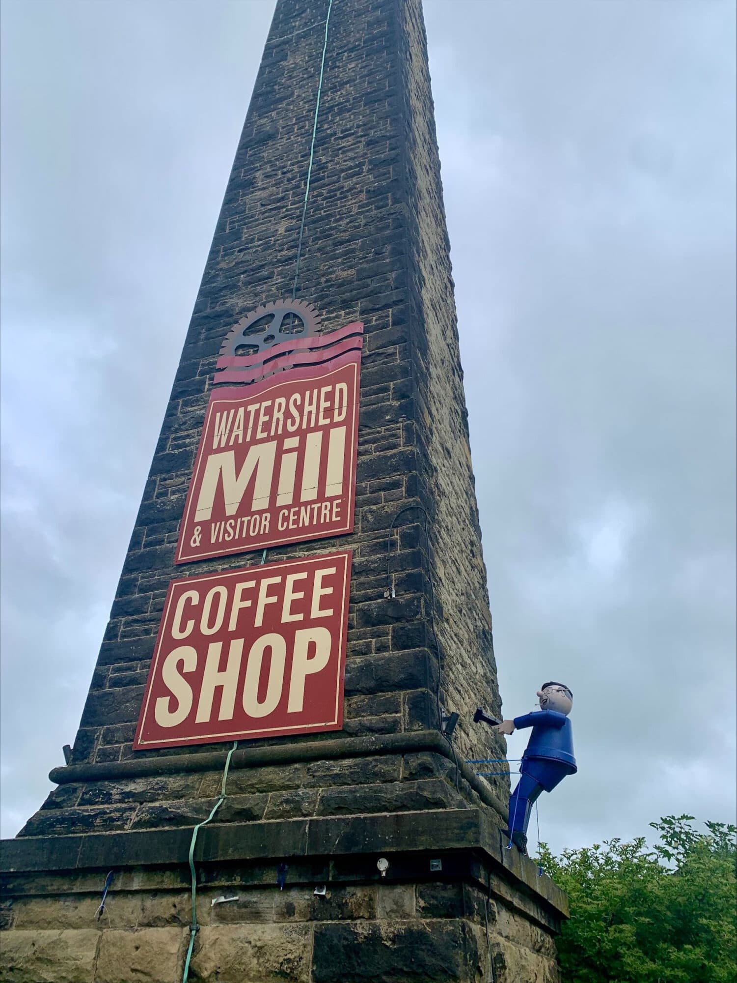Why Is There A Flowerpot Man Of Fred Dibnah Climbing A Mill In Settle?