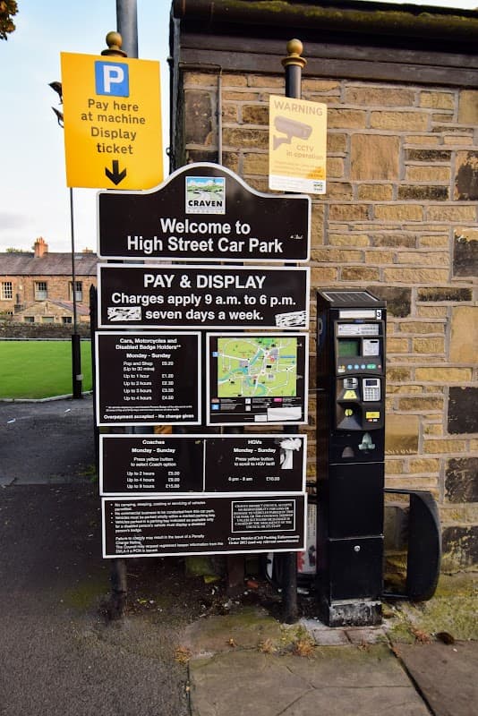 Welcome sign for High Street Car Park with payment instructions, map, and parking regulations displayed.