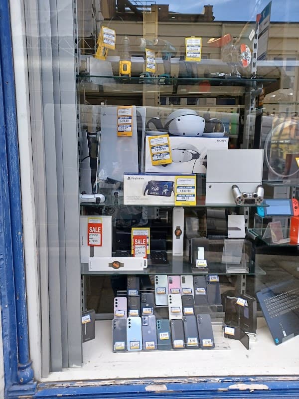 Display window featuring various tech gadgets, electronics, and sale items at Cash Generator Halifax.