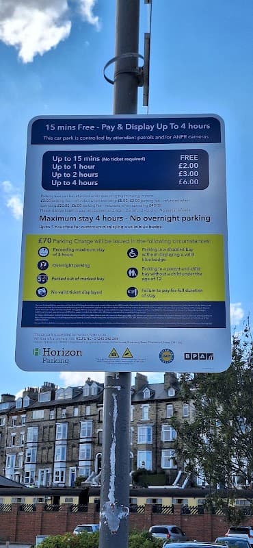 Sign detailing parking regulations and fees at Co-operative Private Car Park in Whitby, Yorkshire.
