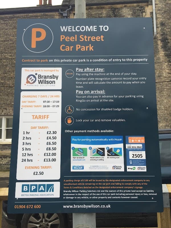 Sign for Peel Street Car Park in York, detailing parking charges, payment methods, and contact information.