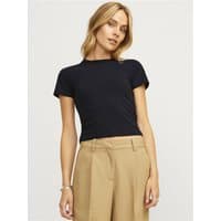 Black Jjxx Gigi Baby Tee, short sleeves, fitted style, worn by model with beige pants.