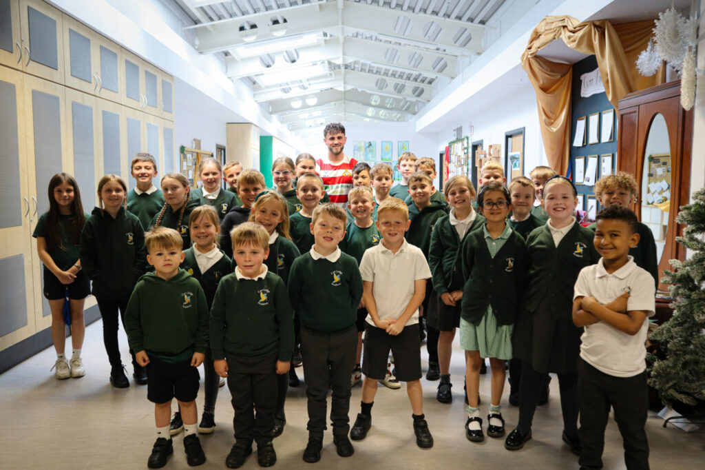 Image name Carr Lodge Academy pupils with Doncaster Rovers full back Tom Nixon the 1 image from the post Attendance4Attendance Relaunched In Doncaster Primary Schools in Yorkshire.com.